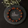 Rudraksha and hematite beaded bracelet arranged in a circle with black and brown beads