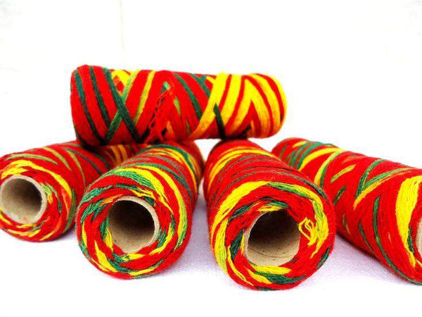 Multicolor yarn skeins, four large coils with hollow centers in red, yellow, and green