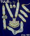 Gold-tone kundan-style shringar set with layered necklace, long earrings, and bangles