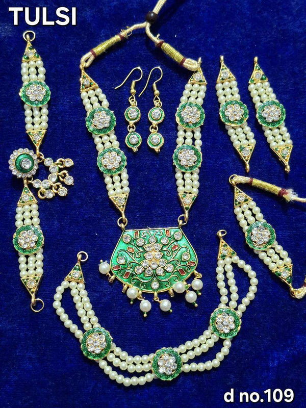 Green and white bead temple jewelry set with necklace, earrings, and pendant