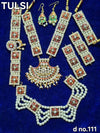 Gold-tone idol jewellery set with red and green stones, pearl beads, earrings and necklace