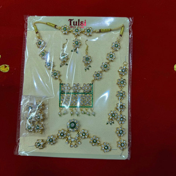 Gold-tone shringar jewellery set with teal stones on display card