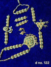 Green-and-gold beaded temple-style jewellery set with pendant, earrings, bangles