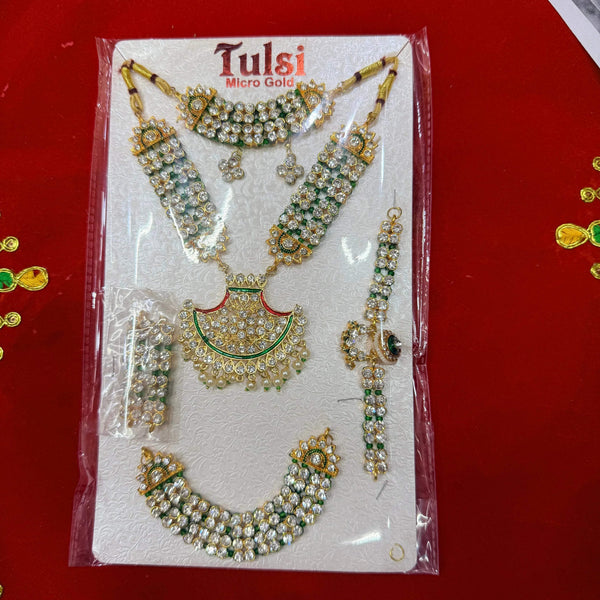 Jewelry set on card: gold-tone necklace with green-stone earrings and bangles