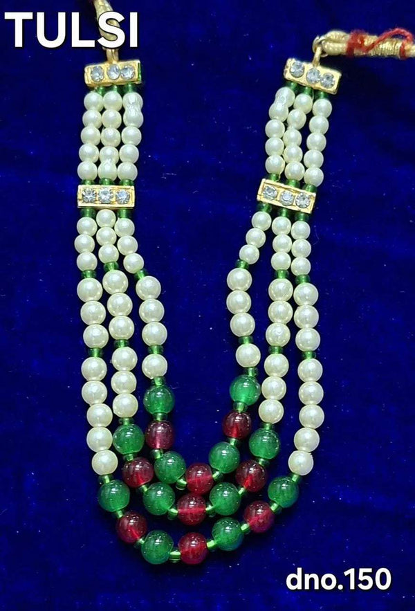 Beaded idol necklace with white beads, green and red accents, and jeweled gold-toned ends