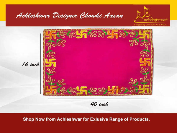 Pink velvet pooja asan with golden border and green-gold embroidered corner motifs.