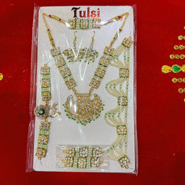 Gold-toned kundan jewellery set on card: pendant necklace, matching earrings, bangles