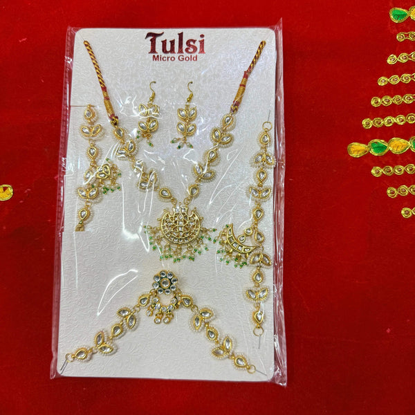 Micro gold jewellery set on card with gold-toned necklace, earrings, and pendant