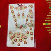 Jewelry ornament set on display card with assorted red and green drop pieces