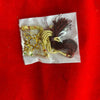 Gold beaded idol decoration with pearls and brown tassels, tied bundle