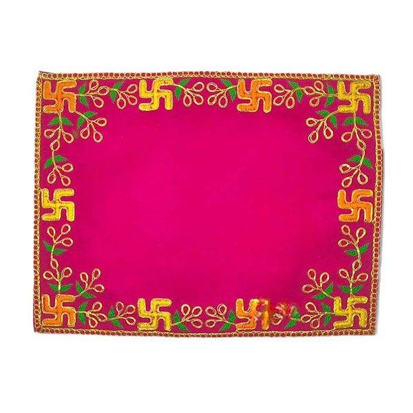 Pink pooja asan with ornate golden border and green-gold embroidered frame design.