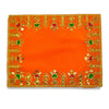 Orange velvet pooja cloth with gold and green embroidered border, centered motifs
