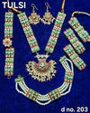 Green gemstone kundan jewelry set with necklace, dangling earrings and matching bangles