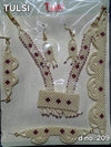 Jewellery shringar set with pearl-like beads and maroon stones, necklace and earrings
