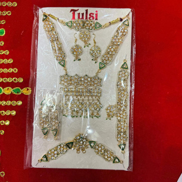 Jewellery shringar set in clear pouch with gold-tone necklace, earrings, and armlets