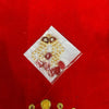 Beaded festive decorative ornament in clear wrap with gold accents and red details