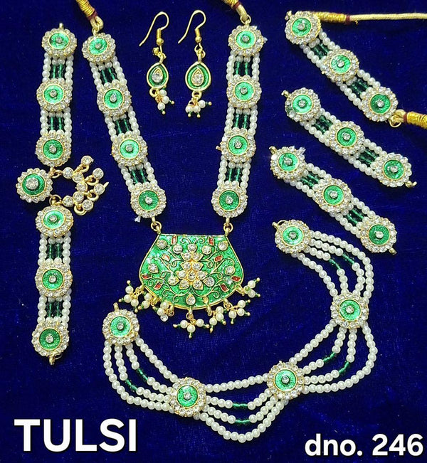 Traditional shringar set with green stone drops and pearl chains; necklace, earrings, tikka