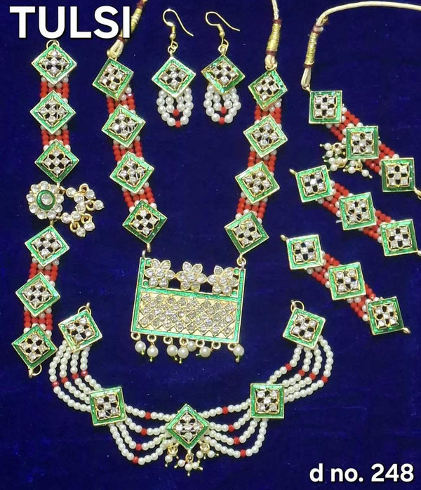 Traditional shringar jewelry set with green square drop motifs, pearls, red and white beads