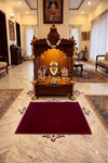 Maroon woolen Aasan rug with ornate trim and central decorative motif