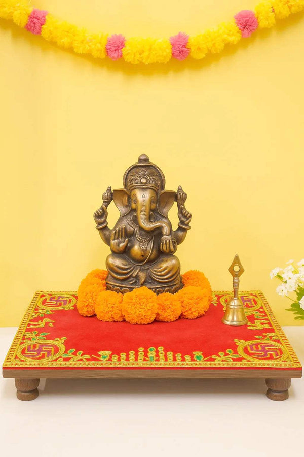 Red embroidered velvet pooja aasan cloth with golden border and floral corner motifs