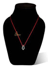 Crystal pendant on red cord necklace displayed on a black bust