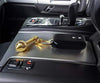 Gold-toned gada keychain locket resting on car center console