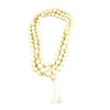 White tulsi bead mala with long white tassel, looped around a handheld shape