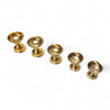 Row of golden brass pooja diyas with shallow fluted cups on pedestal stands
