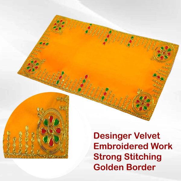 Folded yellow velvet pooja aasan cloth with golden embroidered border and corner motifs