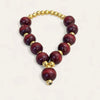 Red bead mala with gold spacer beads and small hanging gold charm