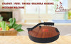 Round wooden papad machine on countertop with black crank handle and red center plate