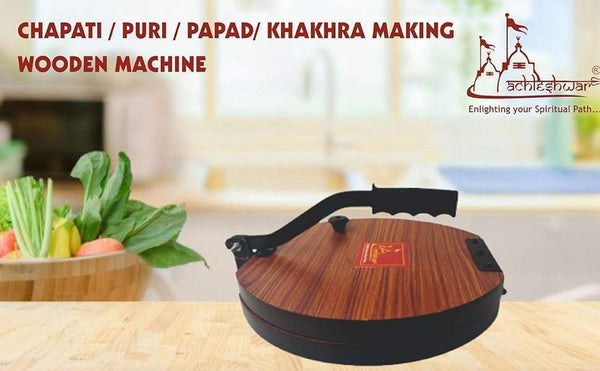 Round wooden papad machine on countertop with black crank handle and red center plate