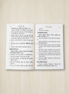 Open Hindi book pages with printed paragraphs and headings