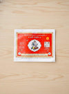 Hindi panchang calendar book with red cover on a light wooden surface