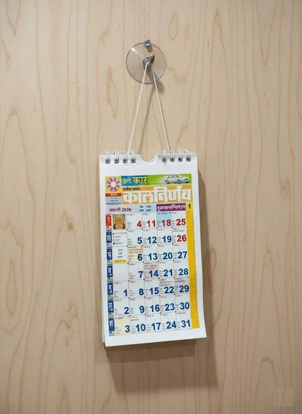 Hanging calendar on wall with spiral top and date grid