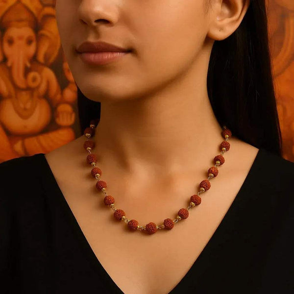 Rudraksha bead necklace with golden caps, brown beads and gold accents on neck.