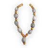 Beaded mala garland with grey beads, gold caps, and cross pendant