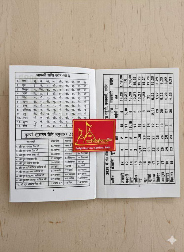 Open paperback astrology book with printed charts and tables on two pages