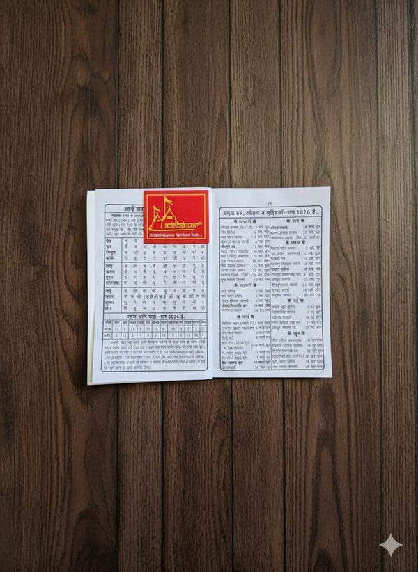 Open astrology jantri rashifal book pages with printed tables and Hindi text