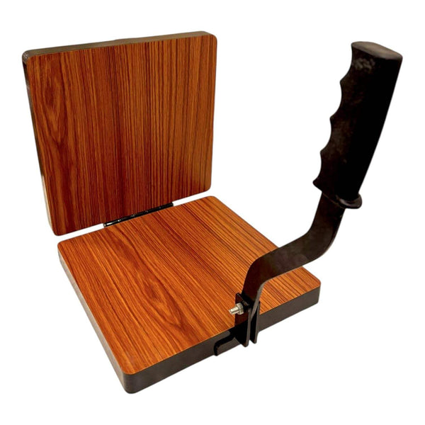 Square wooden press base with black handle lever and metal hinges, roti maker.