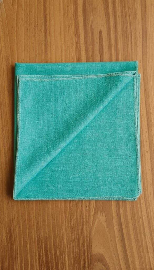 Aqua green woolen meditation mat square, folded edge seams, red brand label