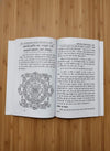 Open Hindi book pages with printed text and a circular diagram
