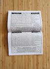Open panchang book with printed tables and grid charts on two pages