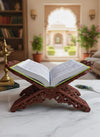 Open Hindi book on a carved wooden stand with two pages of printed text