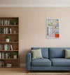 Jain calendar 2026 on wall above sofa, small framed date grid with colorful artwork