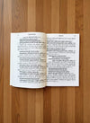 Hindi poetry book open, showing printed text on both pages