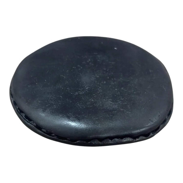 Original Vishnu Chakra shaligram stone, close-up of dark oval smooth surface