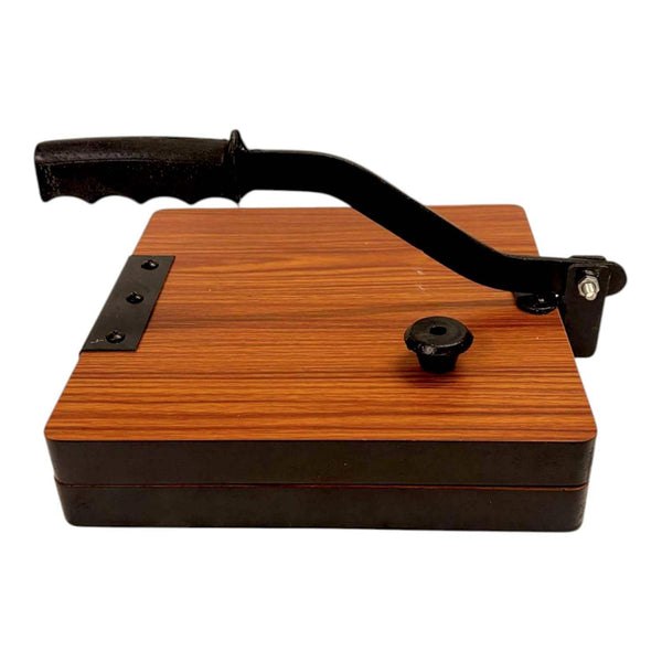 Wooden roti press board with black handle arm, round knob, and iron latch.