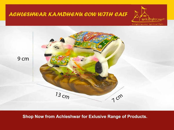Decorative cow and calf figurine with multicolored cloth and brown rock-like base