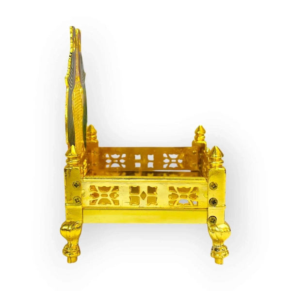 Gold-plated brass singhasan with carved cutwork panels, four legs, and peacock-like crest.